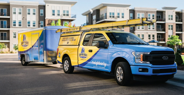 Dryer Vent Wizard truck parked outside of an apartment complex.