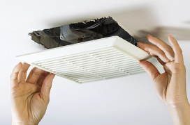 Removing bathroom fan vent cover to clean inside.